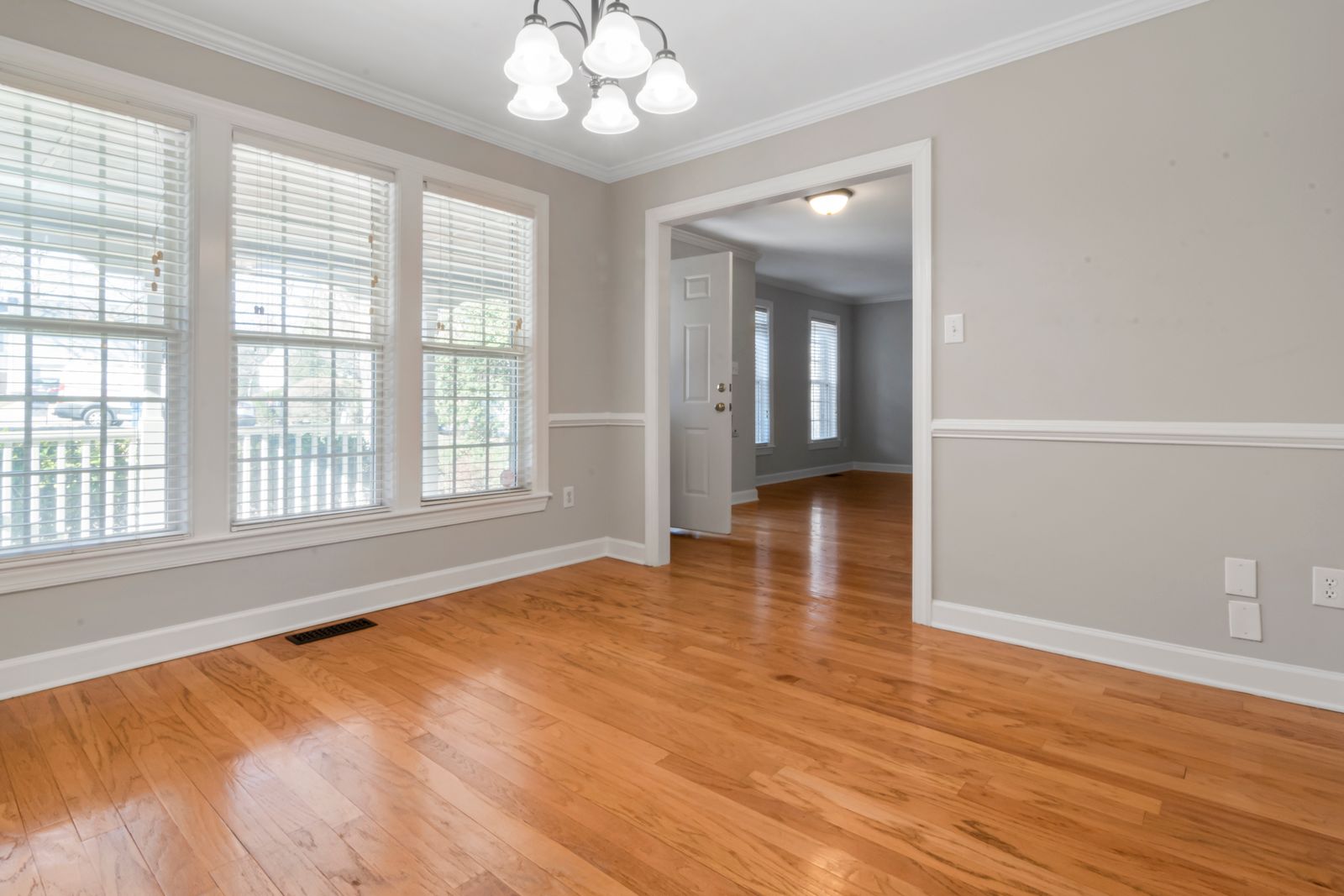 Bright minimalist room with wooden flooring and large windows, ideal for interior design inspiration.