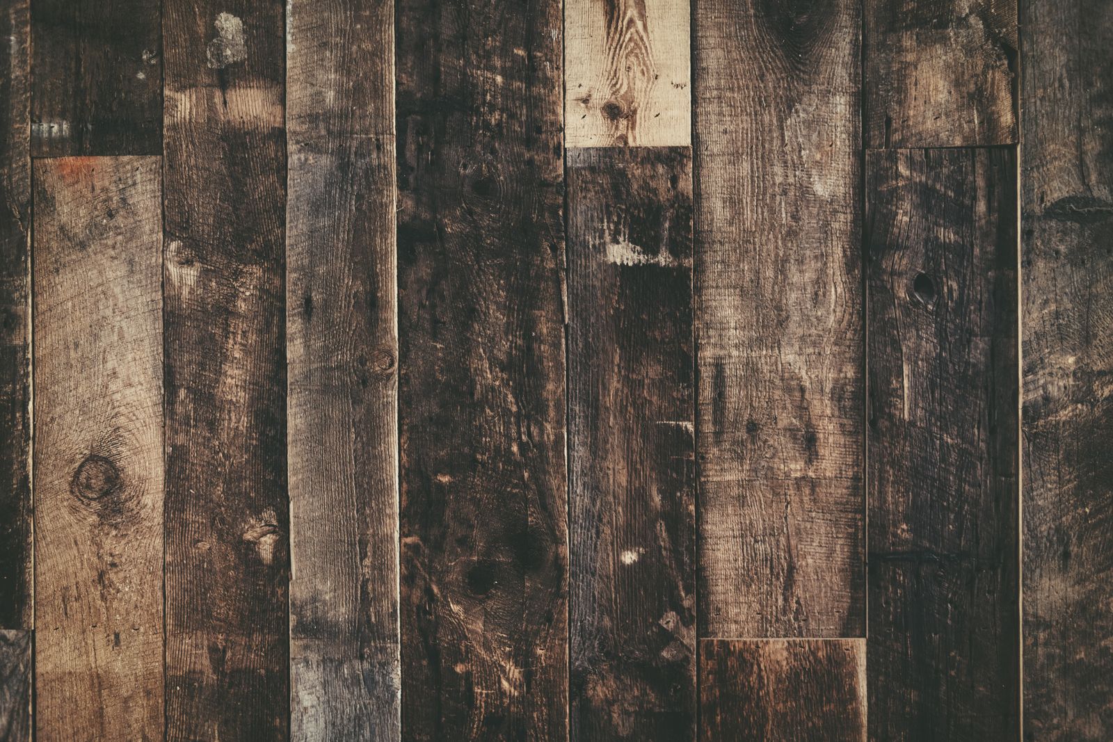 Close-up of weathered rustic wooden planks creating a dark textured background.